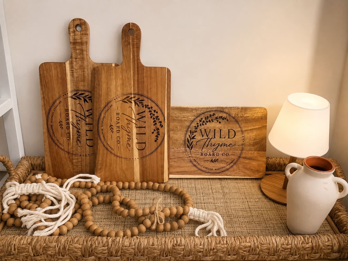 Engraved wooden serving boards branded with the Wild Thyme Board Co logo